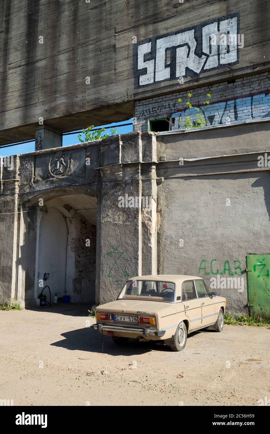 An old Lada car is parked behind the scoreboard of Žalgiris Stadium, now torn down. In Vilnius, Lithuania. Stock Photo