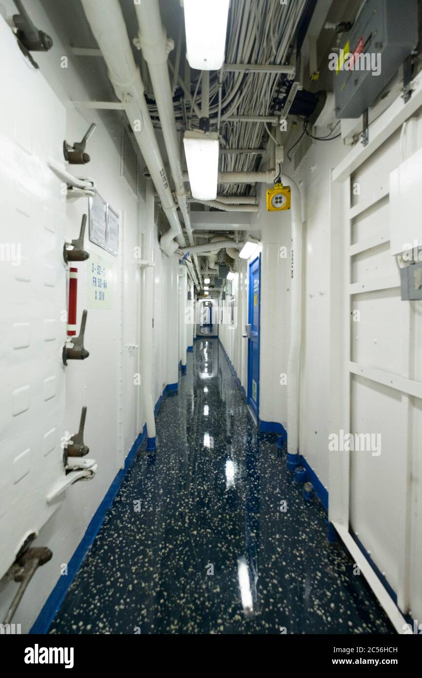 Looking down a typical hallway, corridor of the USS Mount Whitney. At the port in Klaipėda, Lithuania. Stock Photo