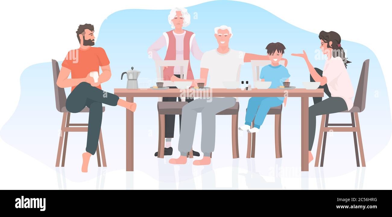multi generation family having breakfast sitting at dinning table ...