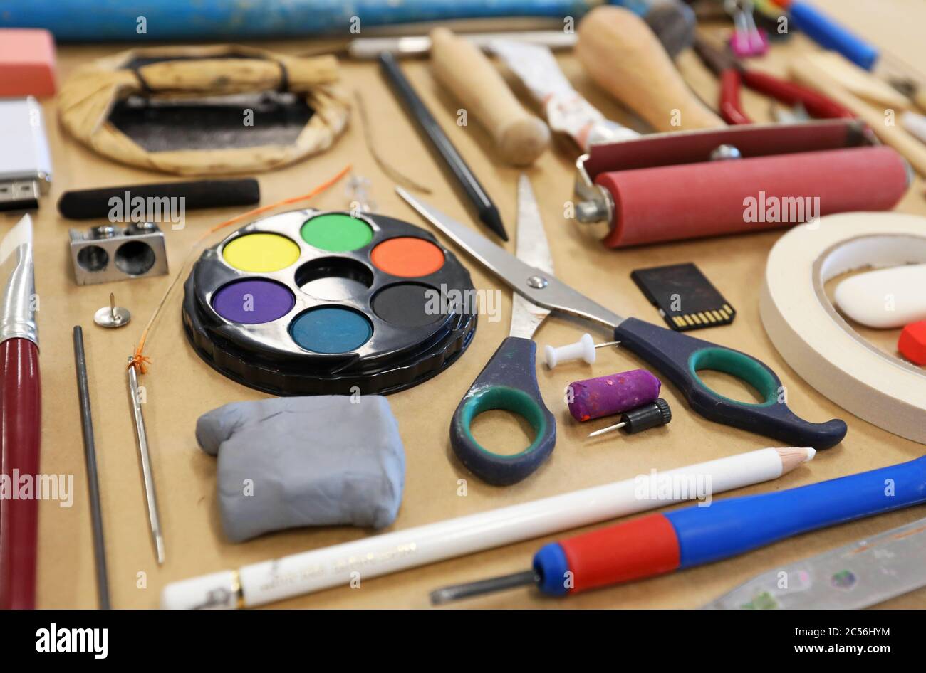 Low angle close up view of visual art artist medias and materials. Scissors paints sharpeners erasers pencils tape pins Creativity art education Stock Photo