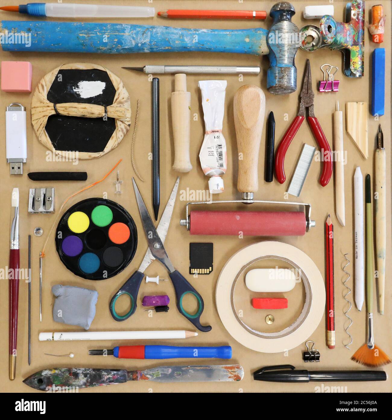 Lay flat view from above of visual art artist medias and materials. Scissors paints sharpeners erasers pencils tape pins Creativity art education Stock Photo