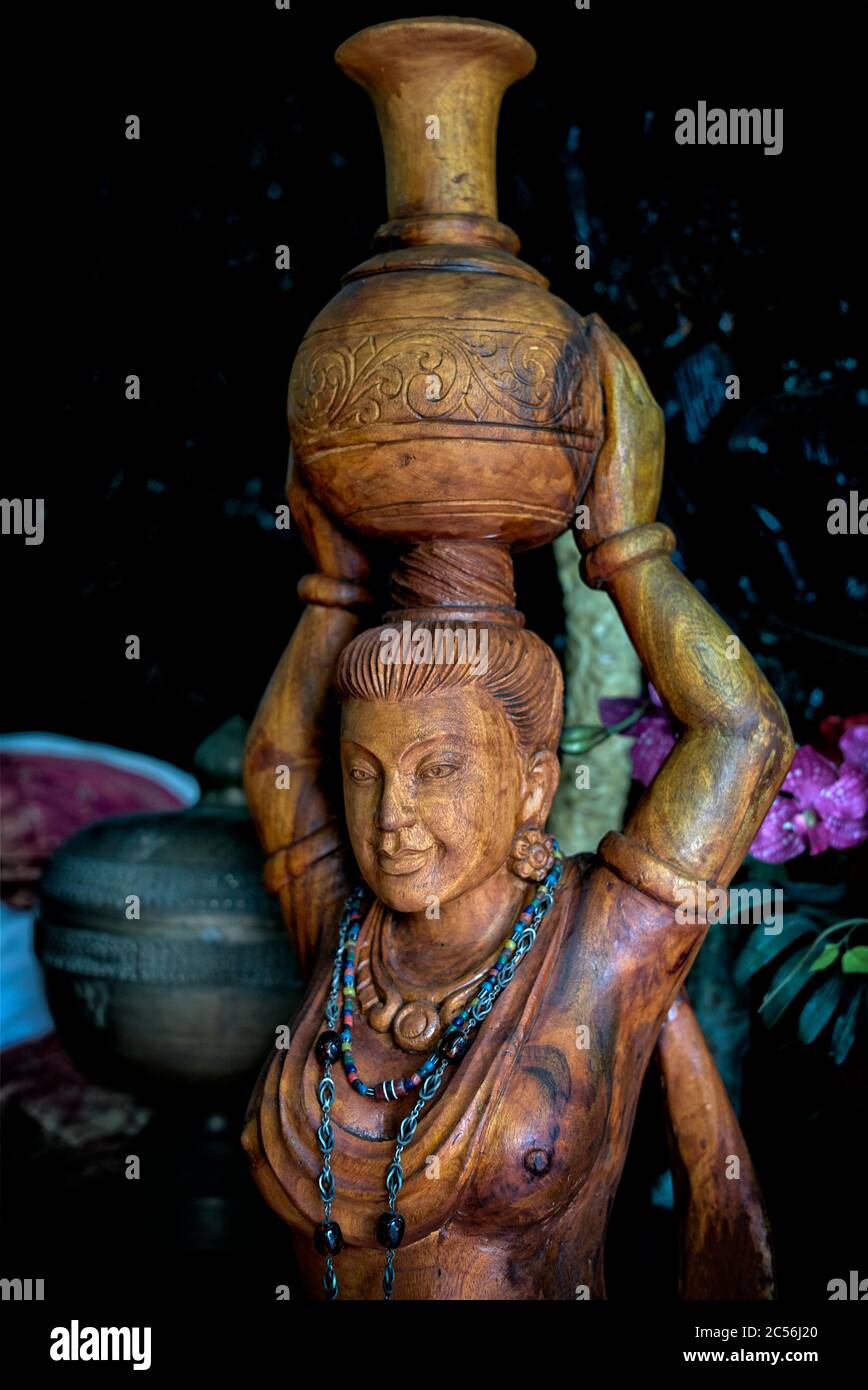 Antique Thailand. Wooden figure of a woman carrying a vase on her head. Thailand, Asian, antiques Stock Photo