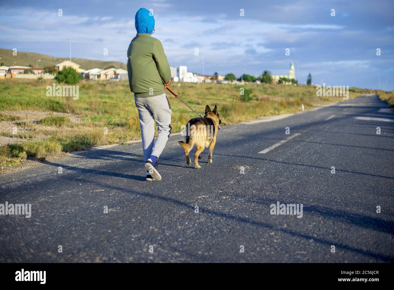 Young boy taking his german shepherd for a walk Stock Photo Alamy