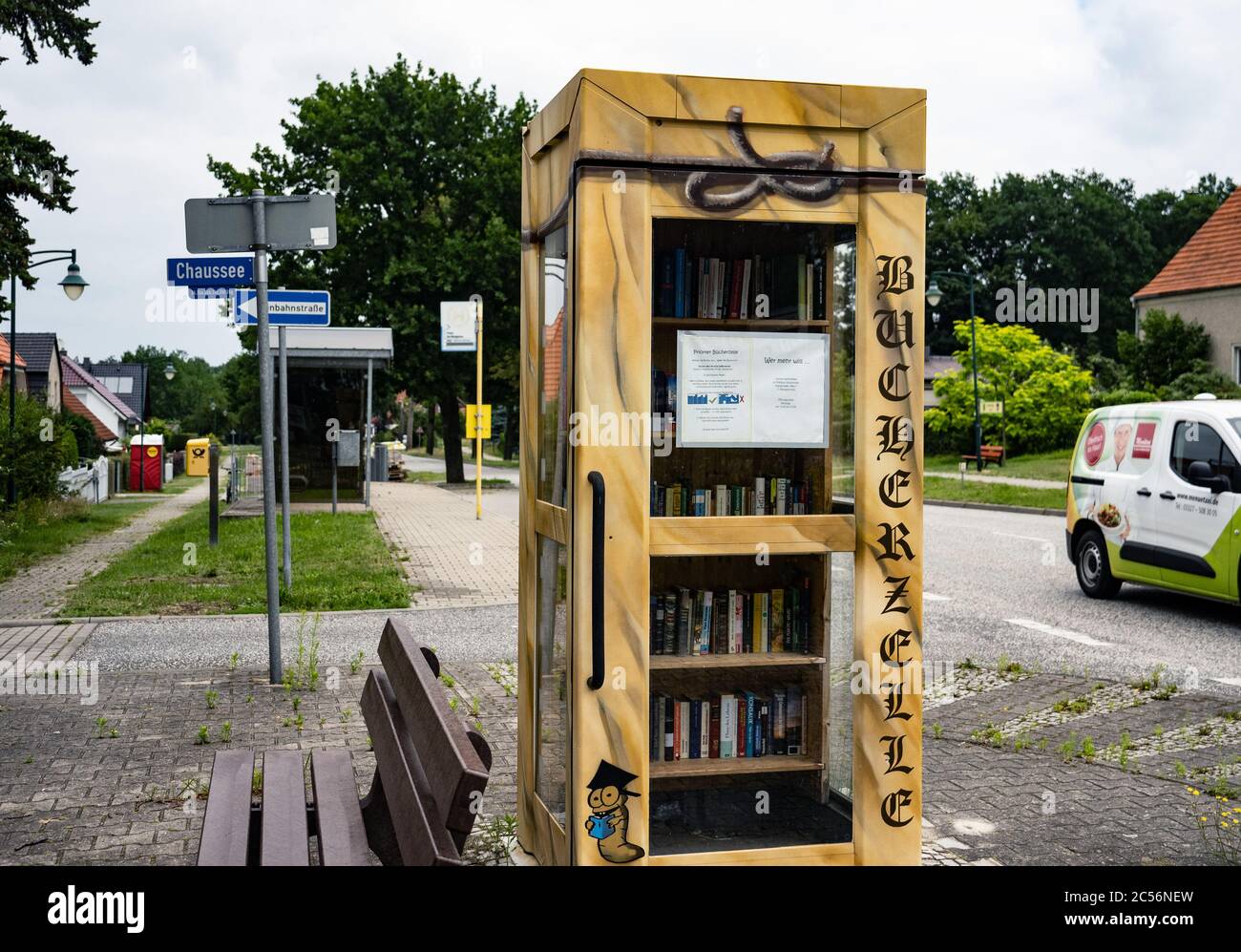 Priort, Germany. 25th June, 2020. The 'book box', a former telephone booth in Priort, Brandenburg, has been artistically designed. There, bookworms can take out books free of charge in exchange. Credit: Paul Zinken/dpa/Alamy Live News Stock Photo