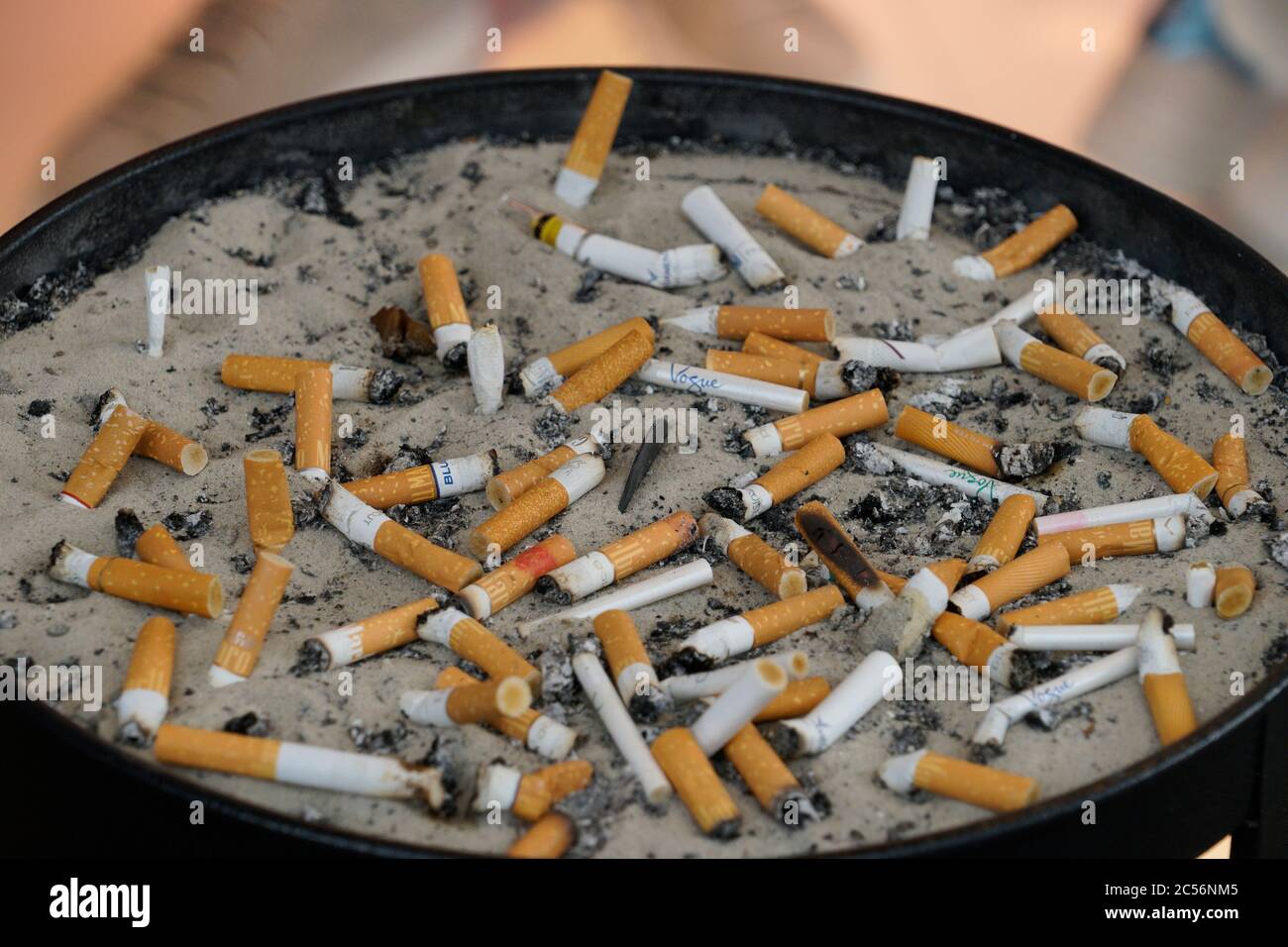 Large ashtray, cigarette butts, expressed, outside Stock Photo