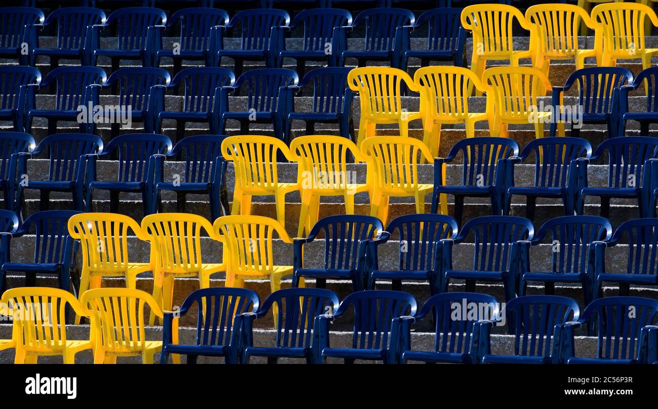 25 June 2020, Saxony, Dresden: Yellow chairs stand upside down, as spacers,  at the film nights on the banks of the Elbe in the rows of seats on the  Königsufer. The open-air