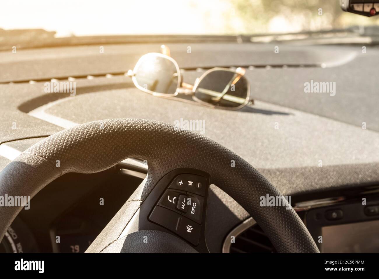 Sunglasses lie on the dashboard of a car while waiting for a ride Stock Photo Alamy