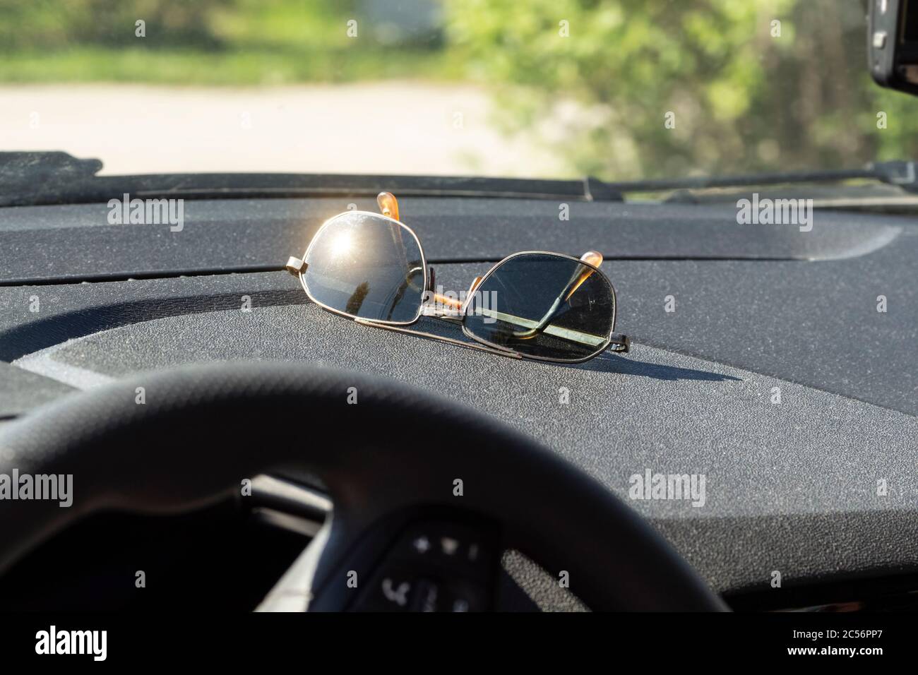 Sunglasses lie on the dashboard of a car while waiting for a ride Stock Photo Alamy