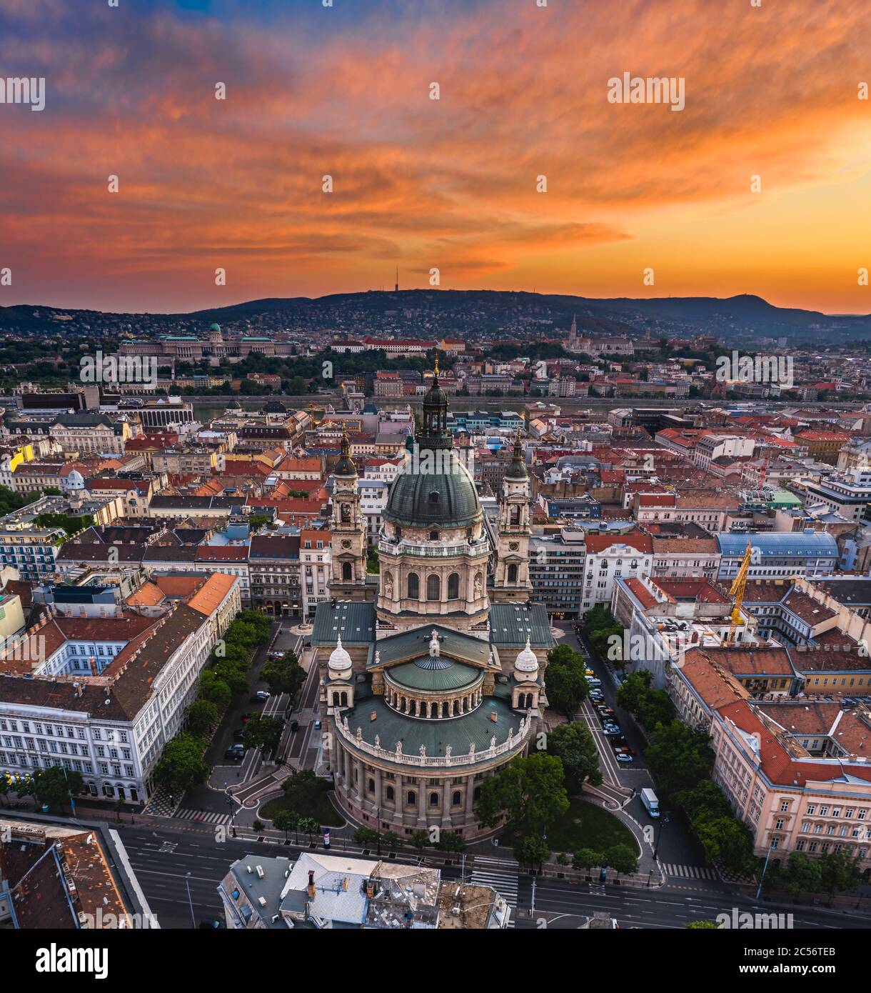 Budapest, Hungary - Aerial panoramic skyline view of St. Stephen's Basilica with a dramatic colorful sunset and Szechenyi Chain Bridge, Buda Castle Ro Stock Photo
