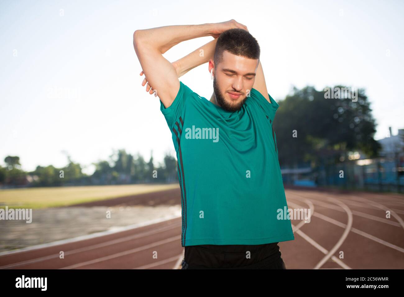 Active young man stretching hi-res stock photography and images - Alamy
