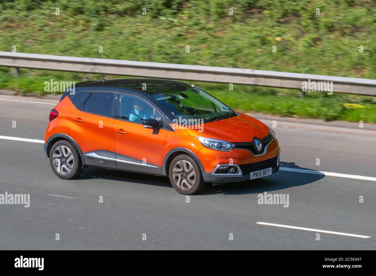 2015 orange black Renault Capturd-Que S M-Nav NRG D; Vehicular traffic moving vehicles, cars driving vehicle on UK roads, motors, motoring on the M6 motorway highway network. Stock Photo