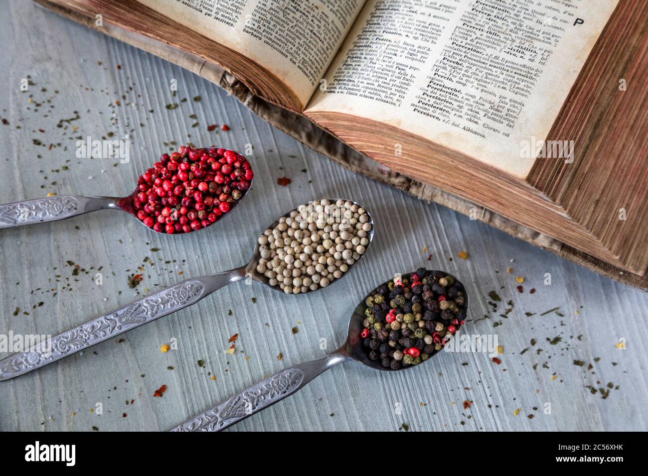 spoons full of multicolored peppercorns, pepper, spices Stock Photo