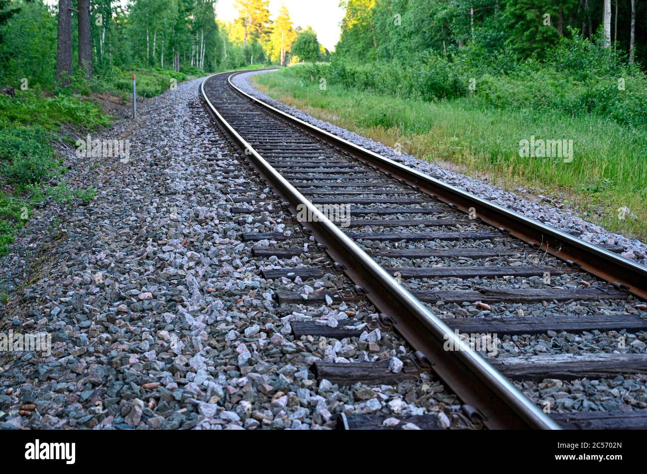low perspective of rail tracks into a bend Stock Photo Alamy
