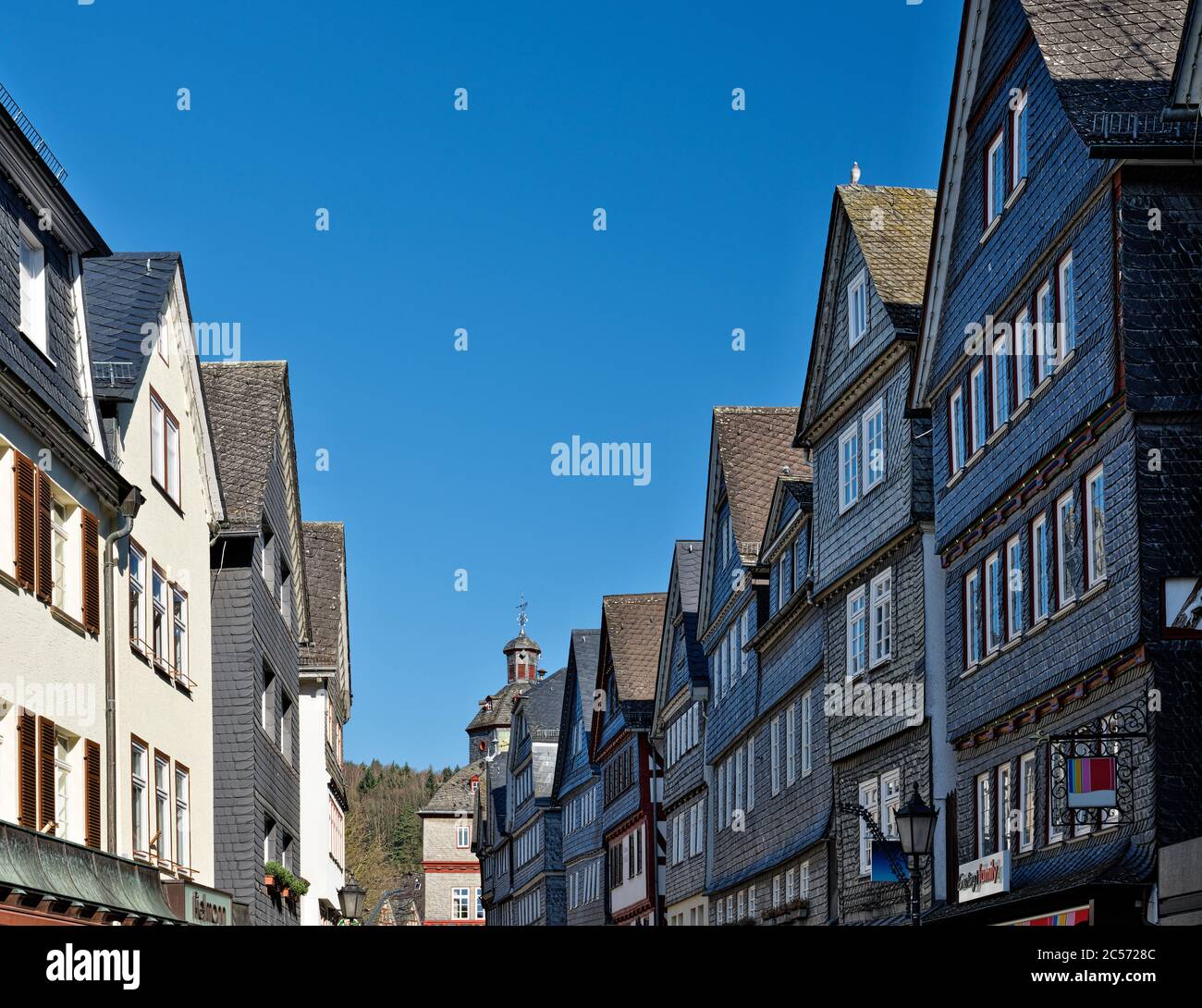 Europe, Germany, Hesse, Lahn-Dill-Bergland Nature Park, city of Herborn, slated houses in the main street, view to the market square with the town hal Stock Photo