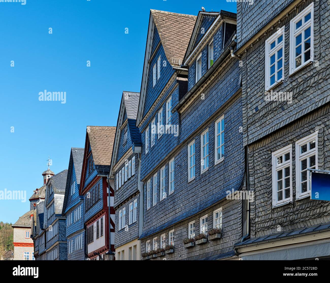 Europe, Germany, Hesse, Lahn-Dill-Bergland Nature Park, city of Herborn, slated houses in the main street, view to the market square with the town hal Stock Photo