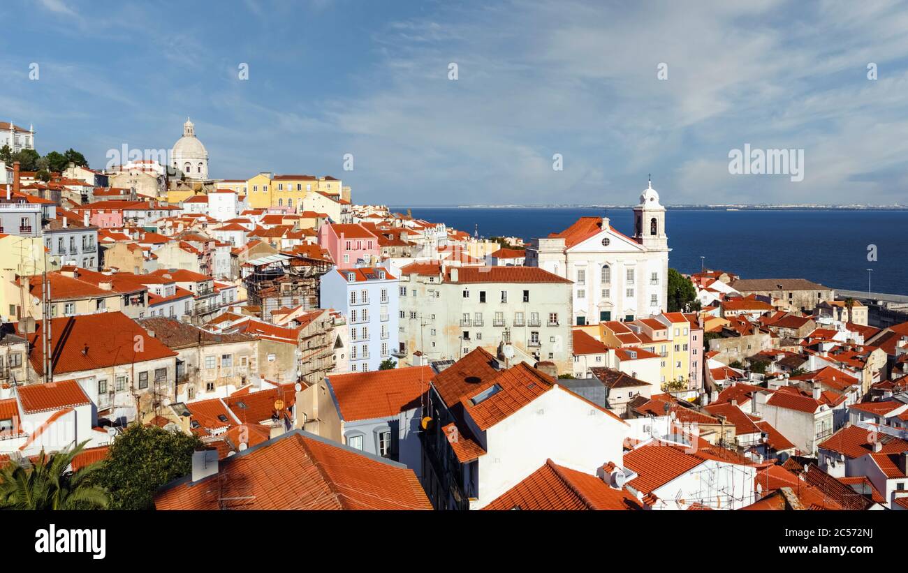 Lisbon, Portugal.  View over the old district of the Alfama with church of Santo Estevao to right and the Rio Tejo, or Tagus River, behind. Stock Photo