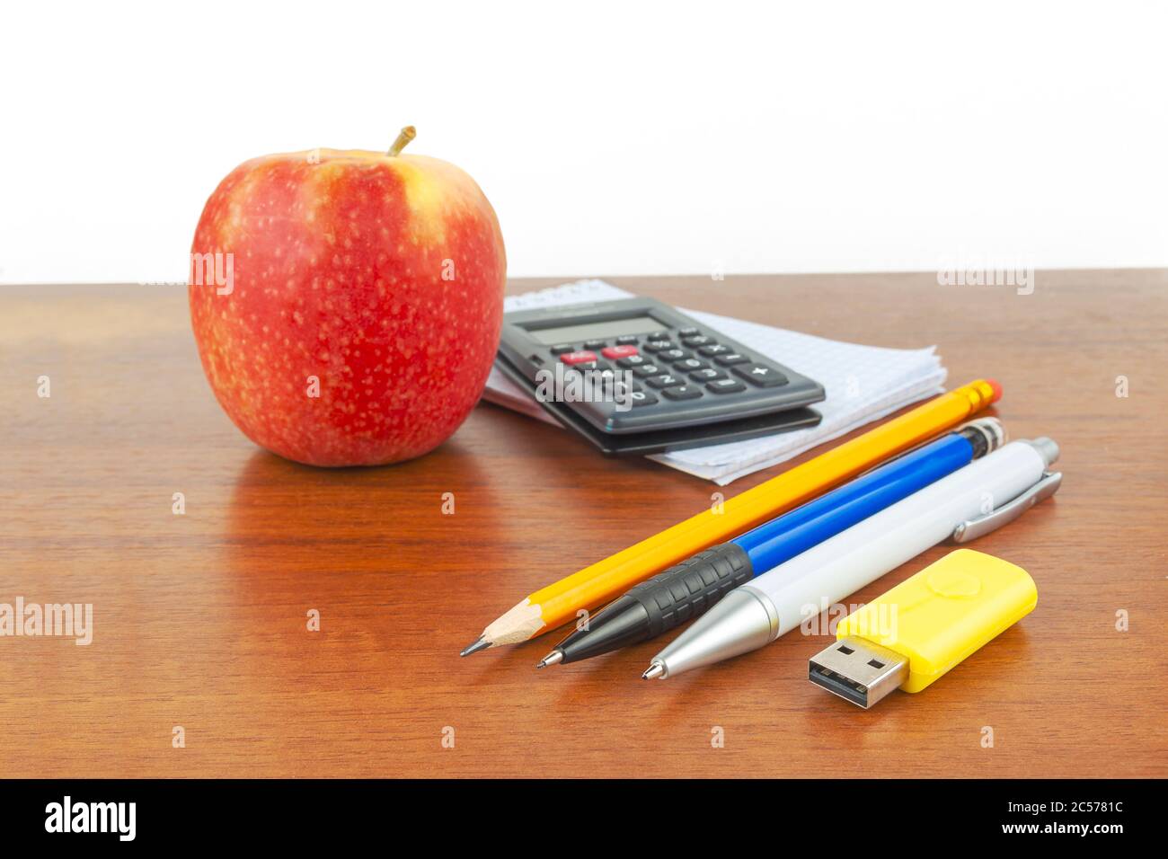 Apple pen notepad calculator lie on the table. Stock Photo