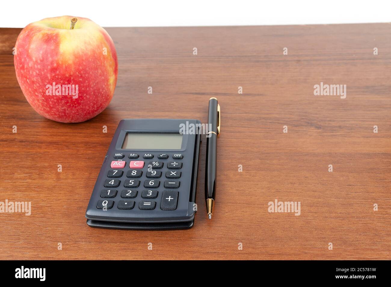 Apple calculator pen lie on the table. Stock Photo
