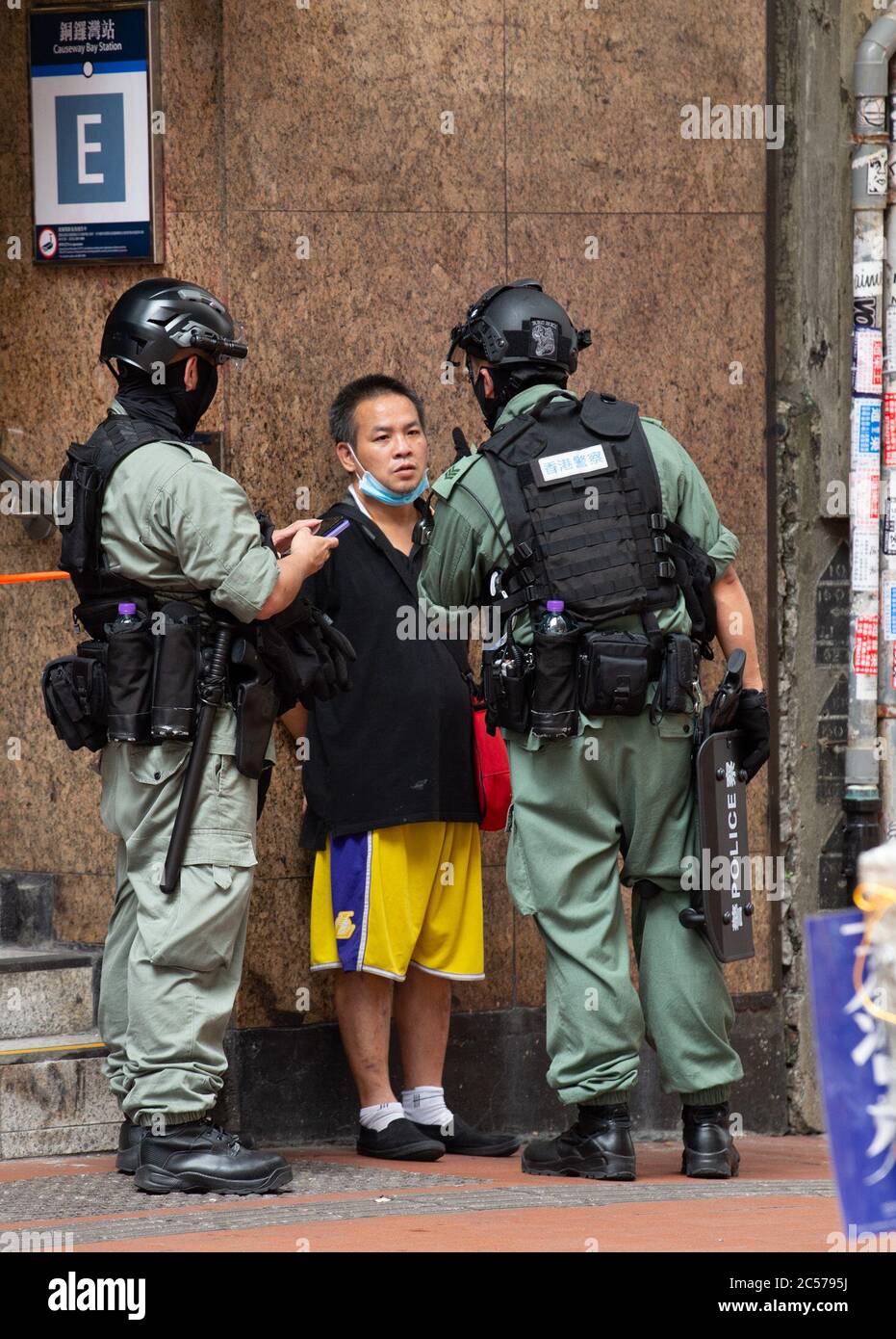 Hong Kong, Hong Kong, China. 1st July, 2020. A man is stopped and searched under new rules.Hong Kong Special Administrative Region Establishment Day. Twenty-three years after Hong Kong was handed by Britain back to Chinese rule, Beijing is pushing to implement tough new national security laws that will suppress the pro-democracy protests seen in the city.It will shatter the Sino-British Joint Declaration where China agreed to the One country, Two systems government.The banning of traditional marches for the first time, has infuriated the public. Credit: Jayne Russell/ZUMA Wire/Alamy Live News Stock Photo