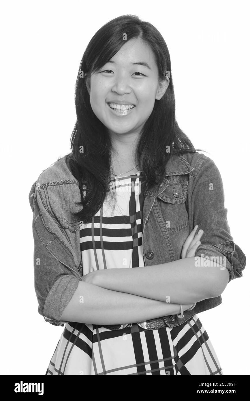 Portrait of happy young beautiful Asian businesswoman smiling with arms ...
