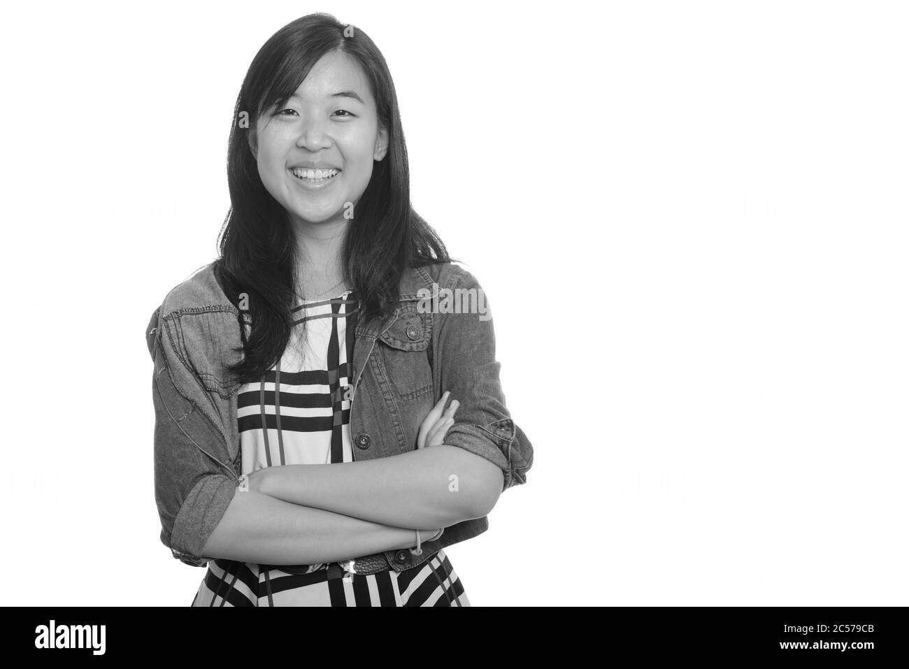 Portrait of happy young beautiful Asian businesswoman smiling with arms ...