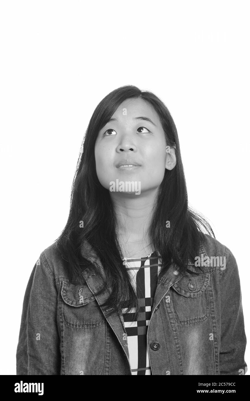 Portrait of young beautiful Asian businesswoman thinking Stock Photo ...