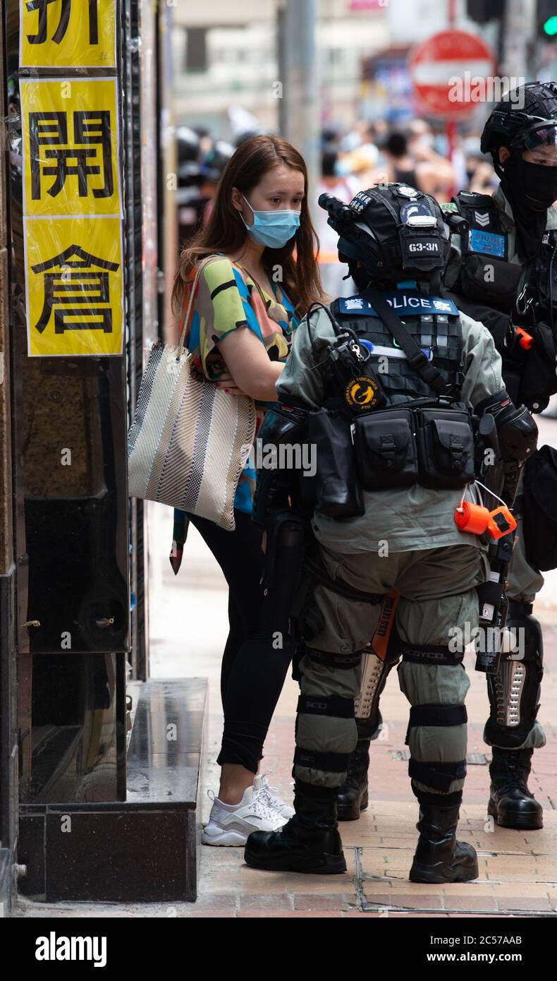 Hong Kong, Hong Kong, China. 1st July, 2020. Powers to stop and search have been extended. A girl is stopped in Causeway Bay.Hong Kong Special Administrative Region Establishment Day. Twenty-three years after Hong Kong was handed by Britain back to Chinese rule, Beijing is pushing to implement tough new national security laws that will suppress the pro-democracy protests seen in the city.It will shatter the Sino-British Joint Declaration where China agreed to the One country, Two systems government.The banning of traditional marches for the first time, has infuriated the public. (Credit Image Stock Photo