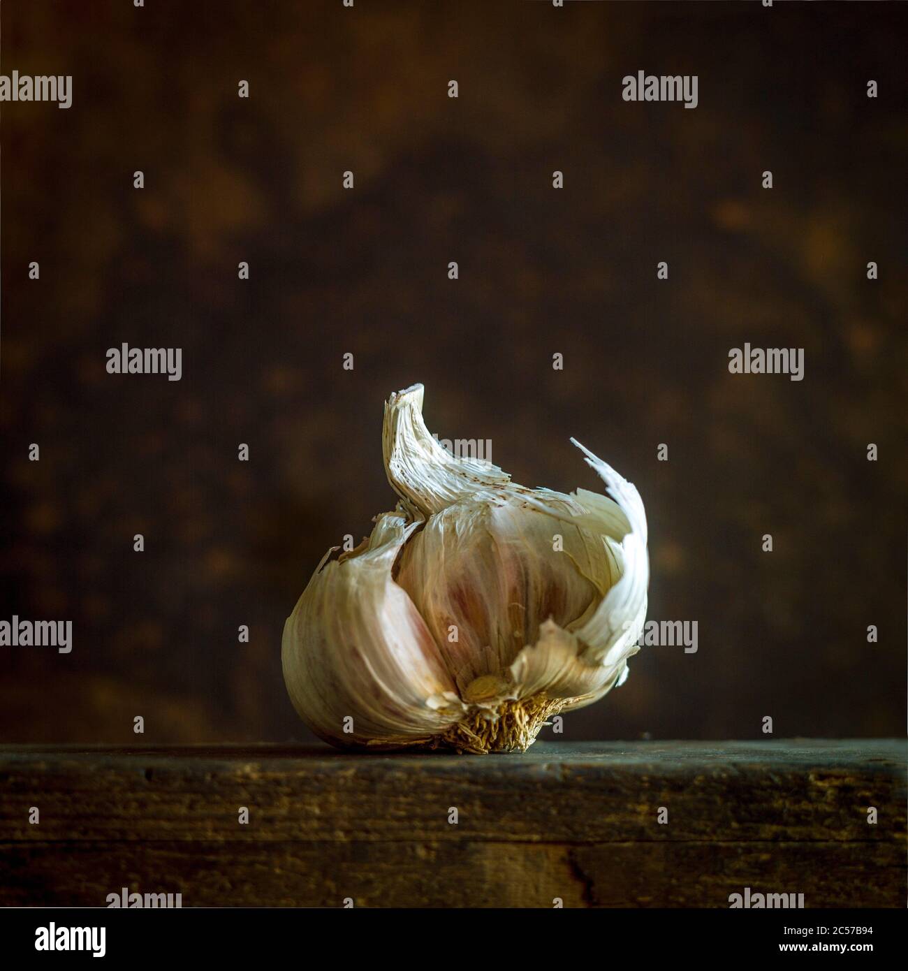 Closeup shot of fresh garlic on a wooden table Stock Photo