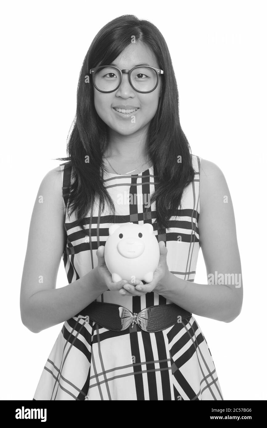 Young happy Asian businesswoman holding piggy bank Stock Photo - Alamy