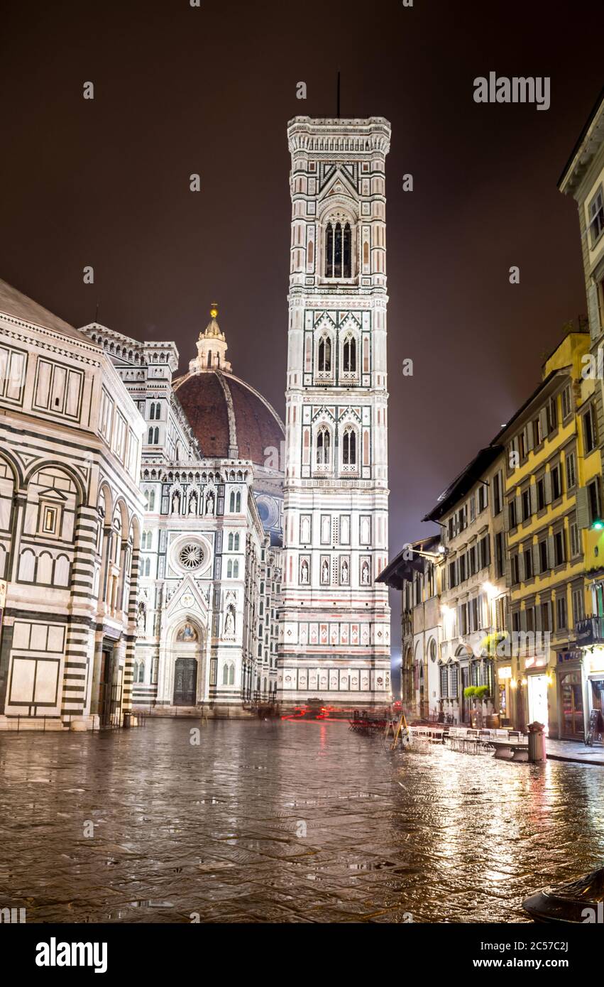 Florence, Italy, 2016. Duomo's square in a rainy evening, the cathedral and the baptistery lit by the street lights Stock Photo