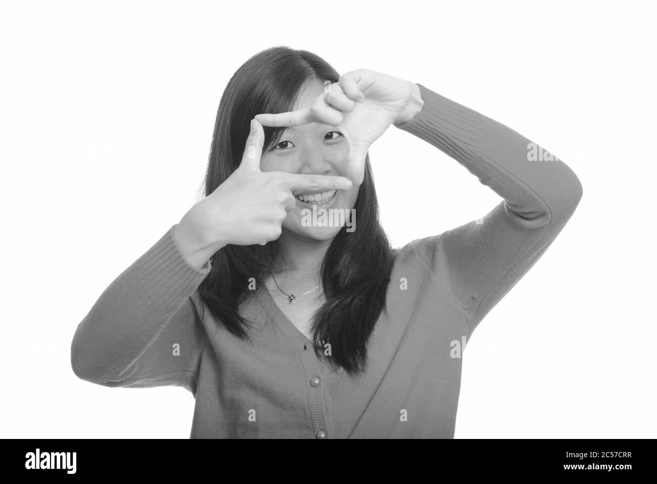 Young happy Asian woman focusing with fingers Stock Photo