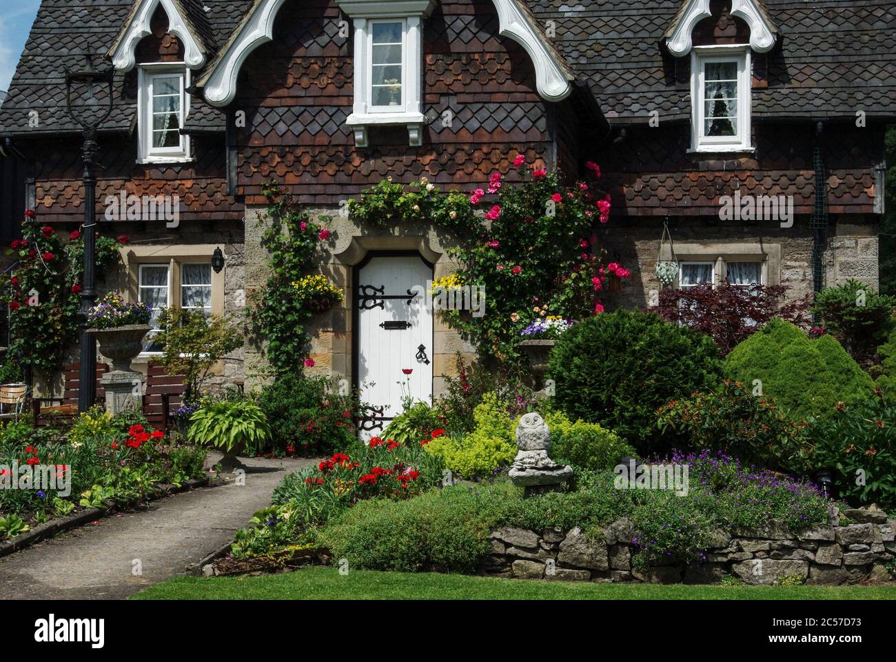 Pretty house and garden in the estate village of Ilam, Staffordshire, UK; many of the houses are built in the Swiss Chalet style. Stock Photo