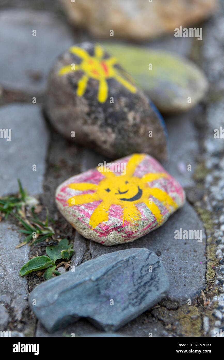 Germany, Saxony-Anhalt, Magdeburg: In front of the Pinocchio daycare center are colored stones with yellow suns. They symbolize hope and joy in diffic Stock Photo