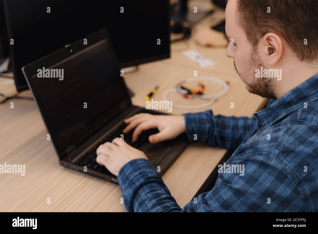 Authentic programmer working on desktop pc programming code technologies or website design at office Software Development Company Stock Photo