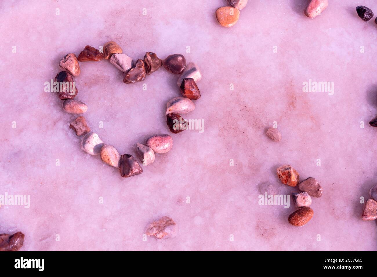Abstract texture of Dead sea. Salty sea shore. Nature background. Heart shape from stones on salt surface. Dead sea shore Stock Photo