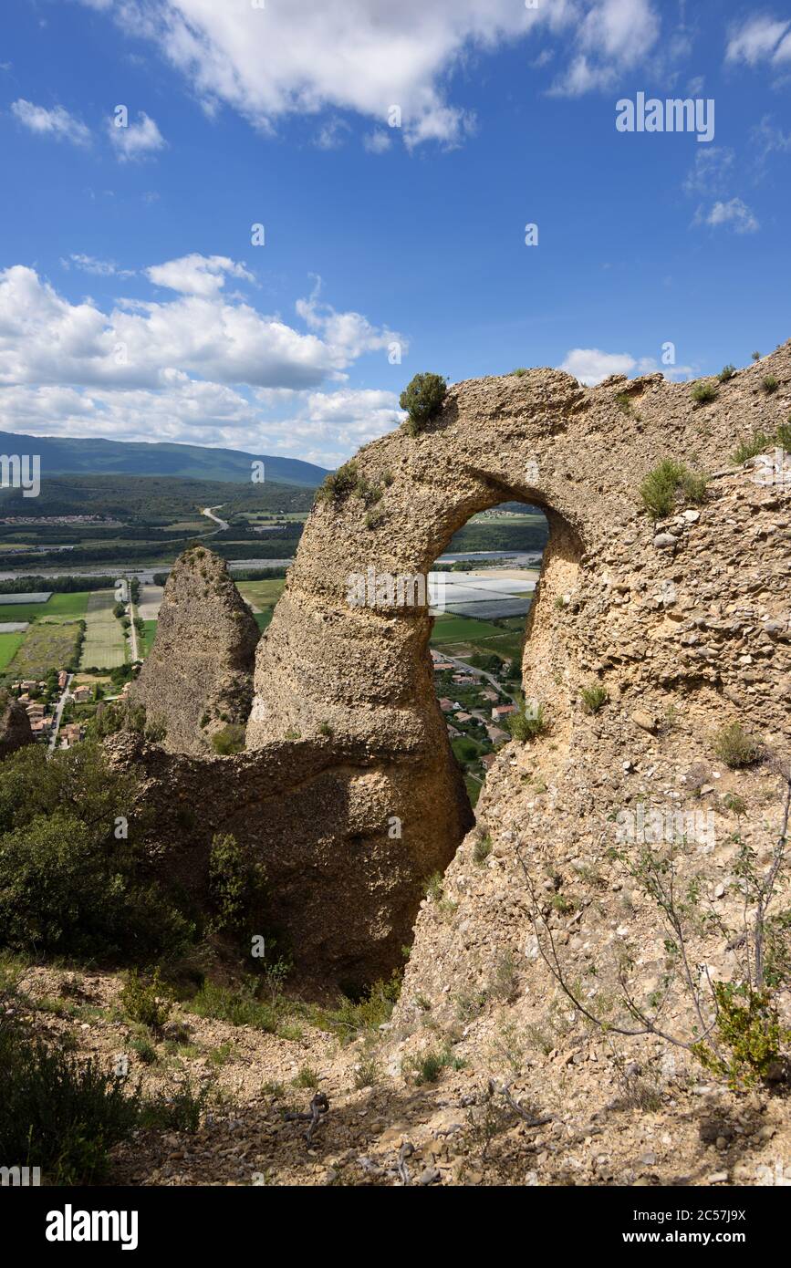 Rock Arch in the Penitents des Mées or Rock Formation & Durance Valley Les Mées Alpes-de-Haute-Provence Provence France Stock Photo