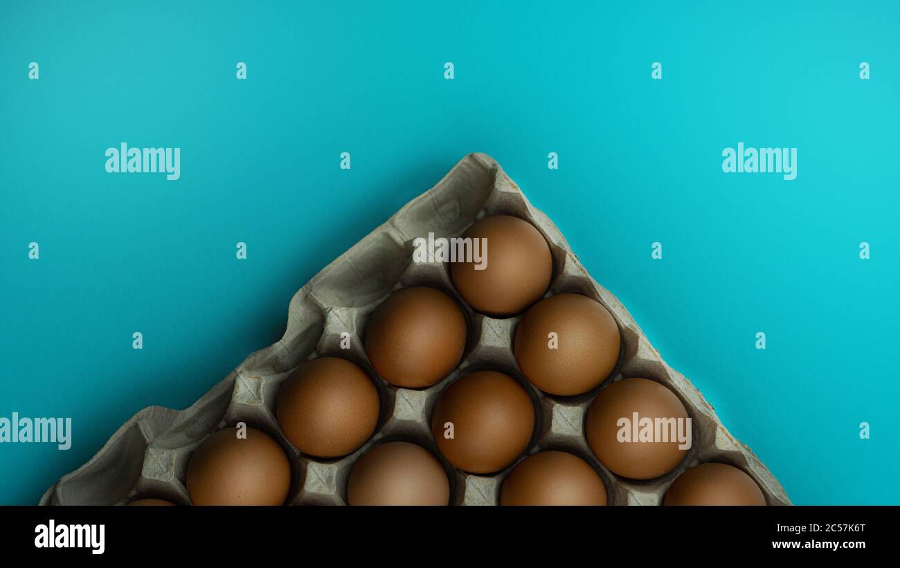 A box of eggs on a blue background Stock Photo