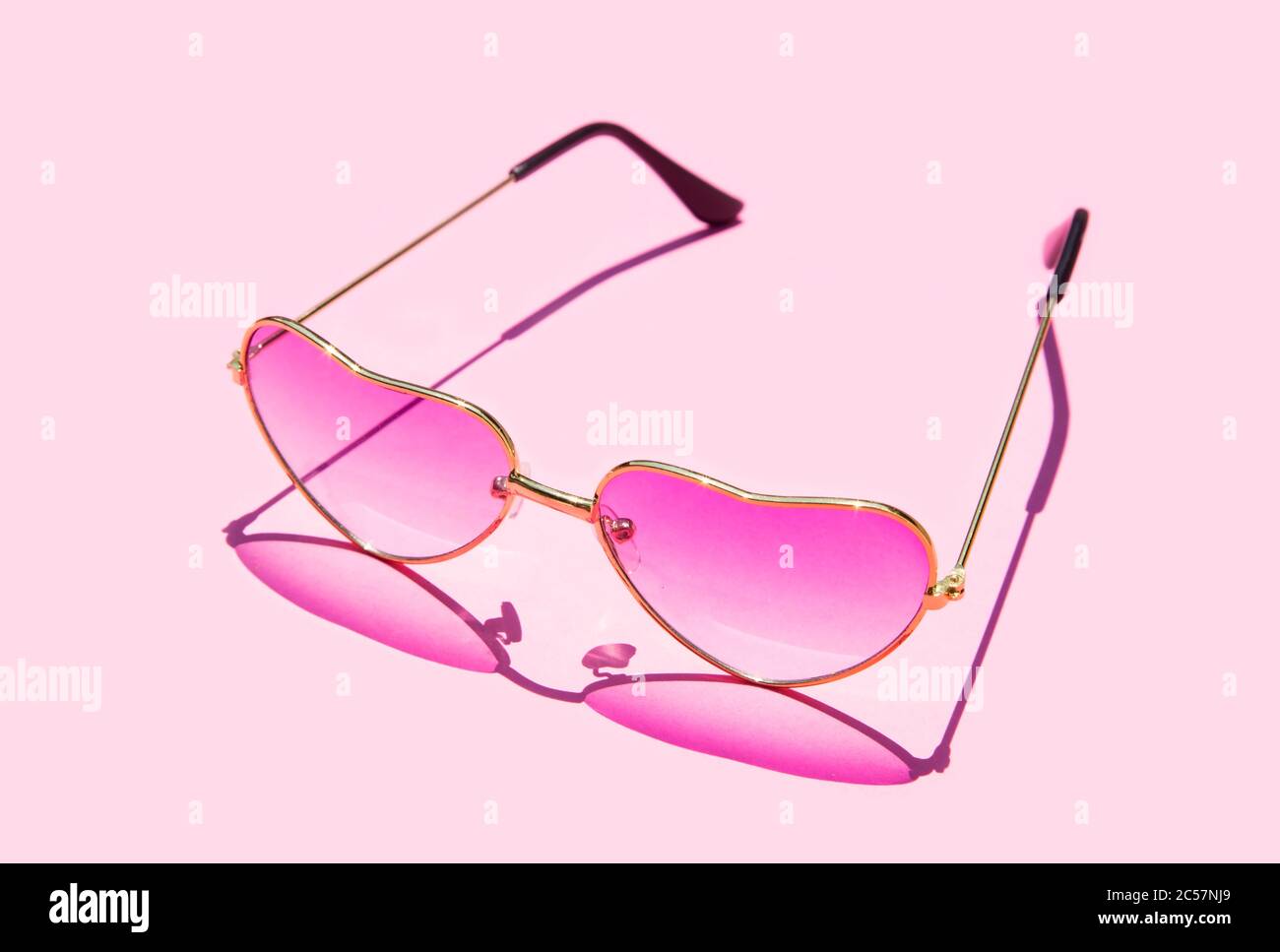 Pink hart shape sunglasses with the shadow Stock Photo