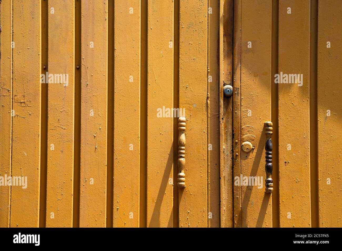 Yellow painted old iron door detail texture Stock Photo