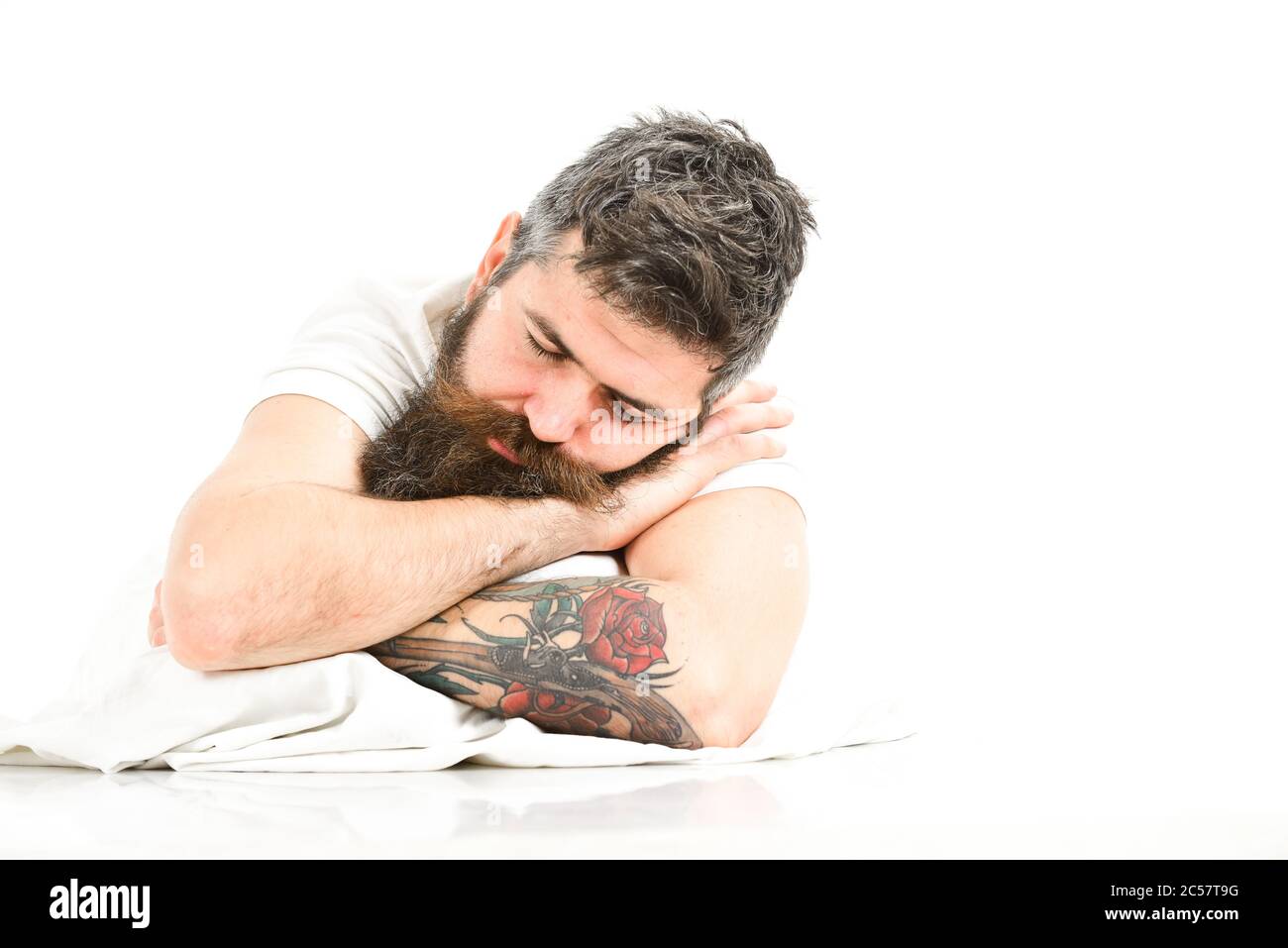 Man with beard and mustache in deep sleep, white background. Hipster