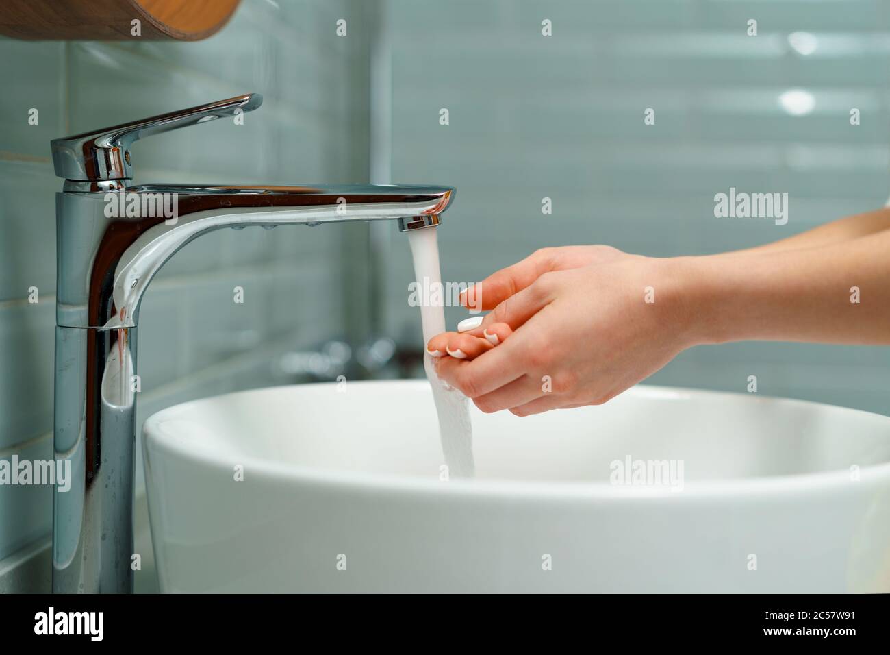 Close up of a woman washing her hands in a bathroom sink Stock Photo ...