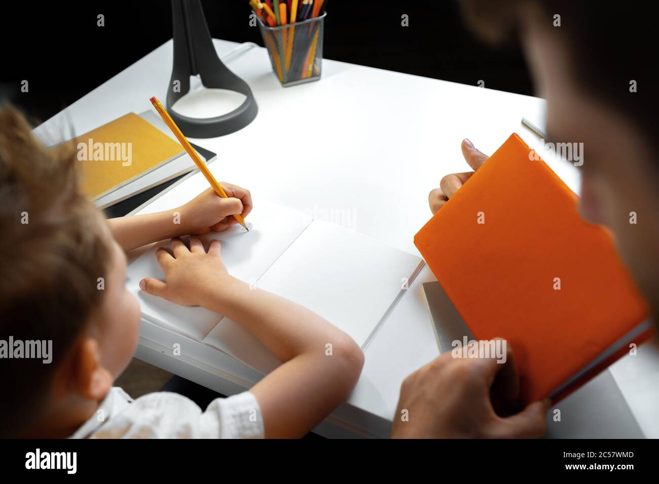 Father helping his little son with school homework Stock Photo - Alamy