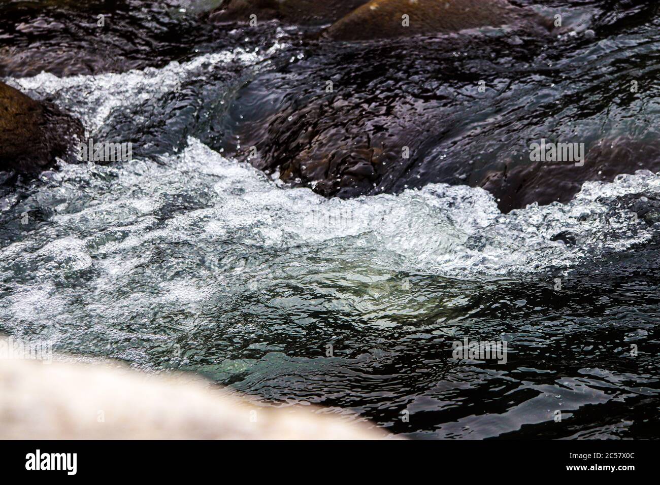 Pebbles in water stream flowing fast hi-res stock photography and ...