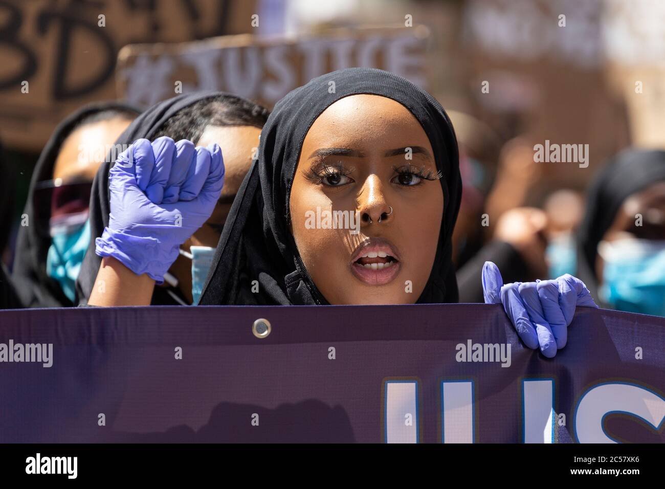 Portrait of a girl wearing rubber gloves at a Black Lives Matter demonstration, London, 27 June 2020 Stock Photo