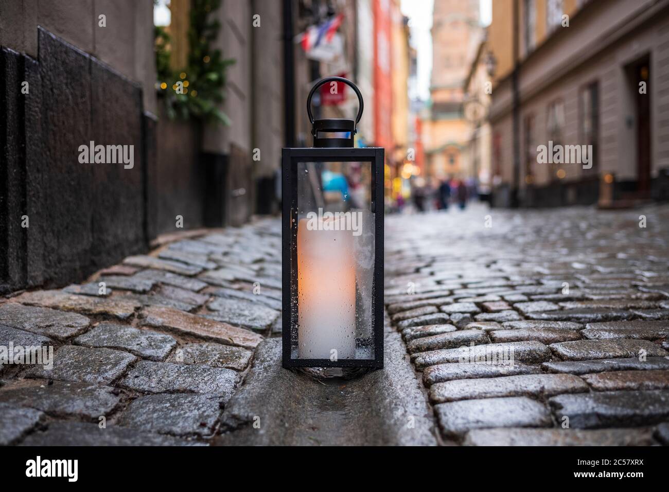 A lantern with a glowing candle rests on a cobblestone street corner in Gamla  stan, the old town of Stockholm, Sweden Stock Photo - Alamy