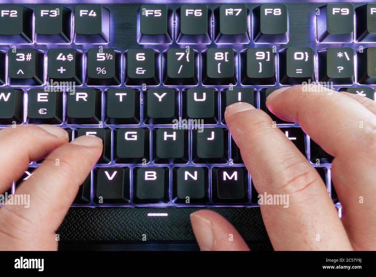 Closeup view of a keyboard with bright led lights for easy and comfortable using pc or notebook. High Tech concept Stock Photo