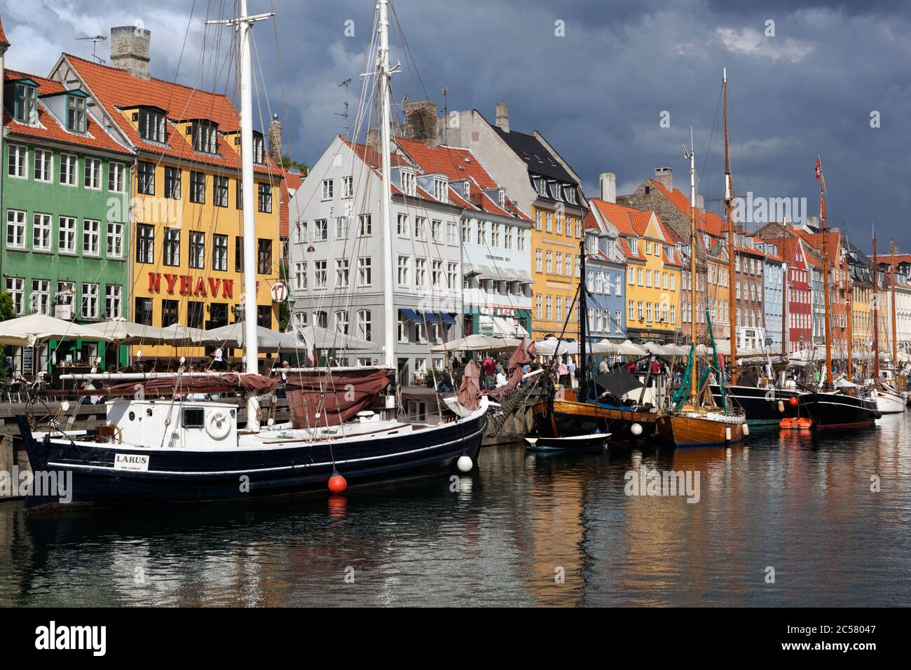 View along Nyhavn (New Harbour) canal lined with boats and former merchant's houses Stock Photo