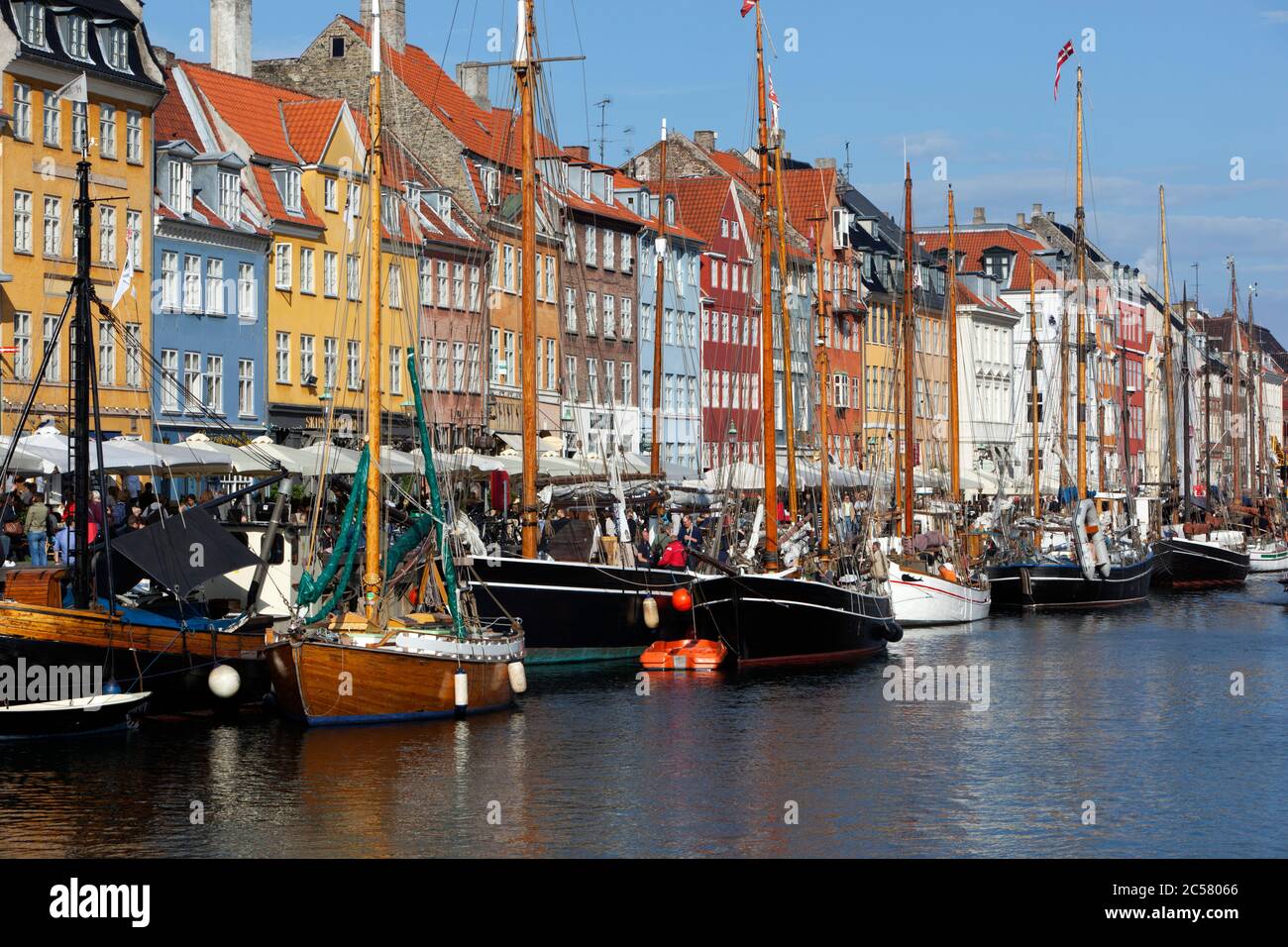 View along Nyhavn (New Harbour) canal lined with boats and former merchant's houses Stock Photo
