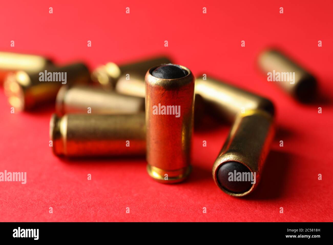 Rubber bullets on red background, close up Stock Photo