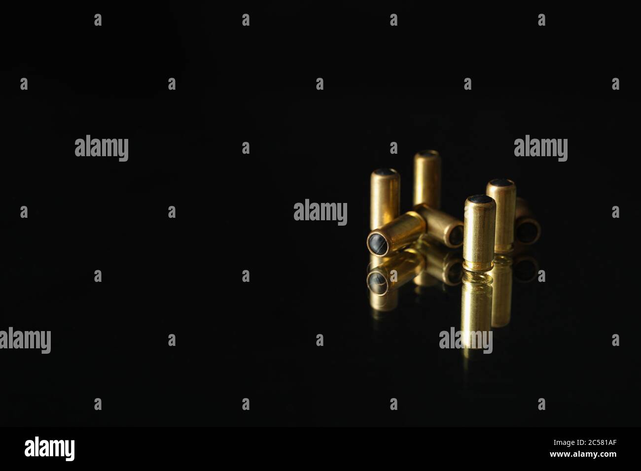 Rubber bullets on mirror background. Self defense weapon Stock Photo